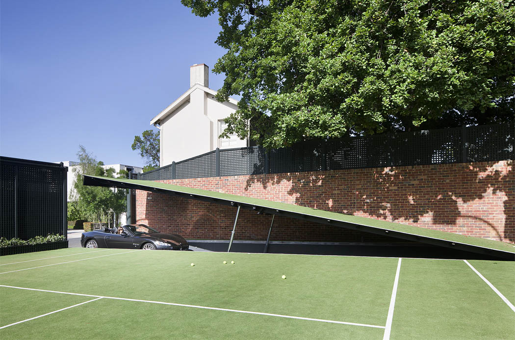 Hydraulic ramp access below tennis court to 'Batcave'