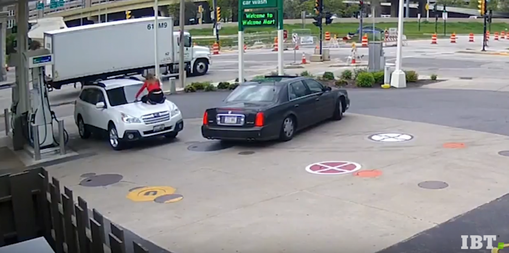 Woman Jumps On Hood Of Her Car To Stop Carjacker At Gas Station!