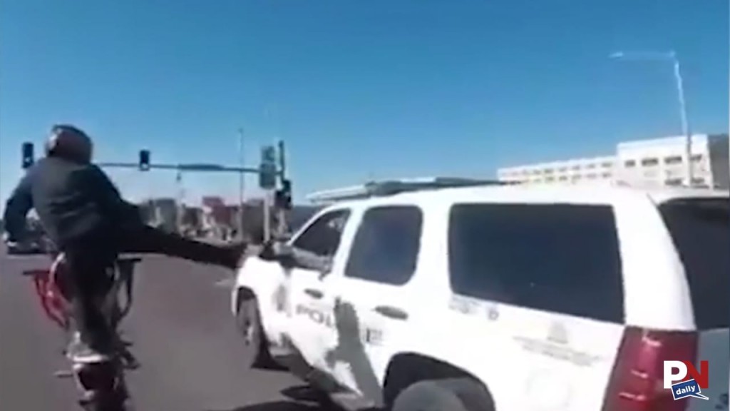 Biker High Fives A Cop As He Wheelies Down The Road