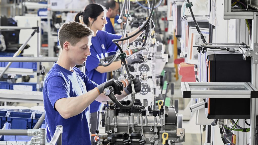 Factory workers building Volkswagen engines in Germany