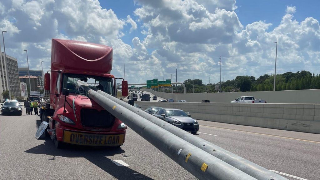 Two utility poles penetrating the cab of a semi truck in Tampa, Florida