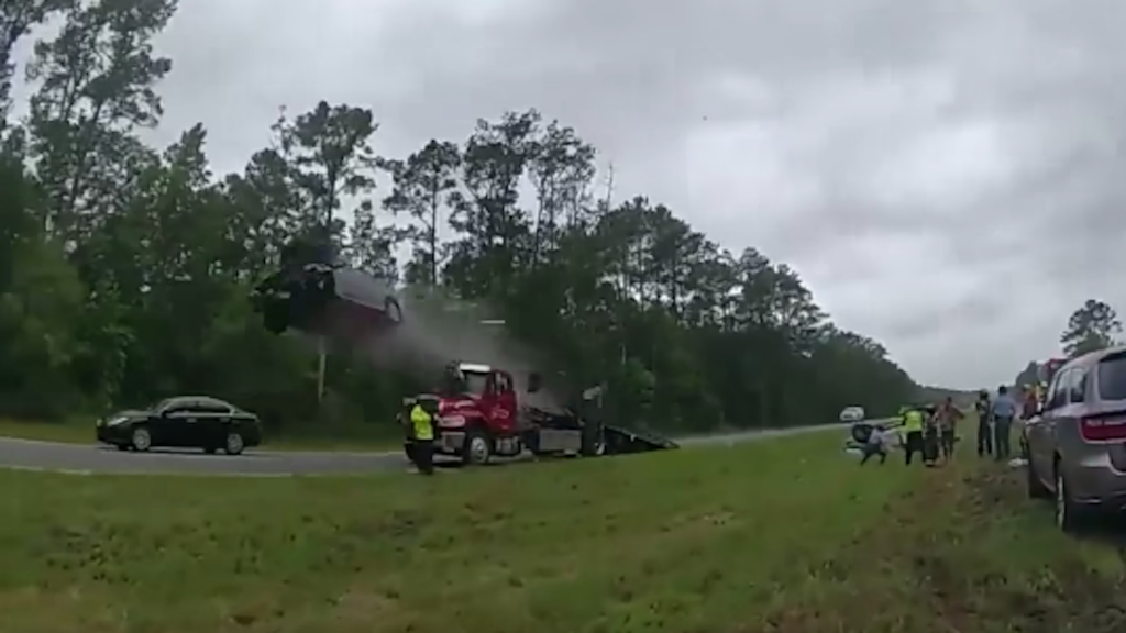 Nissan Altima driver launches itself into the air after driving up a tow truck ramp at a high speed