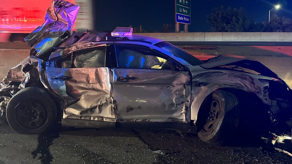 Damaged police car caused by a human waste spill on I-95