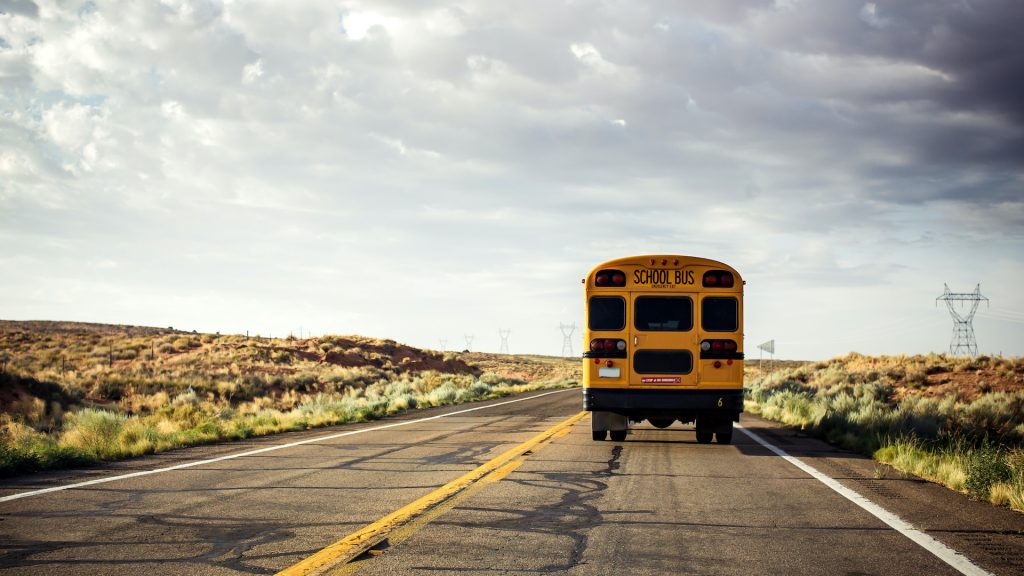 Yellow school bus on the road, USA | Adobe Stock