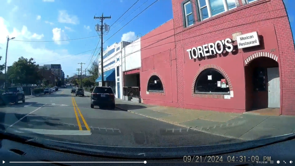 Driver swerves hard right, out of the blue, and crashes into the light pole.